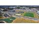 Aerial view featuring community amenities, including a sports field, tennis courts, and playground, close to townhomes at 419 Burr St, Indian Trail, NC 28079