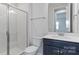 Modern bathroom features a walk-in shower with white subway tile, updated fixtures, and a solid surface vanity at 419 Burr St, Indian Trail, NC 28079