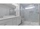 Bathroom features a double sink vanity with marble countertops and a glass-enclosed shower at 419 Burr St, Indian Trail, NC 28079