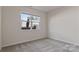Bright bedroom with plush carpet, a large window, and neutral walls at 419 Burr St, Indian Trail, NC 28079