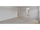 Bedroom features neutral carpeting and a doorway leading to a bathroom at 419 Burr St, Indian Trail, NC 28079