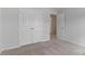 Bedroom features neutral carpeting, closet, and a doorway leading to another room at 419 Burr St, Indian Trail, NC 28079