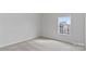 Bright bedroom features neutral carpeting and a window bringing in natural light at 419 Burr St, Indian Trail, NC 28079