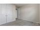 This neutral bedroom offers dual closets, soft carpet, and ample natural light at 419 Burr St, Indian Trail, NC 28079
