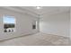 Bright bedroom features neutral carpeting, recessed lights, and two bright windows at 419 Burr St, Indian Trail, NC 28079
