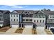 An aerial view of newly constructed townhomes, each with a one-car garage and individual architectural design at 419 Burr St, Indian Trail, NC 28079