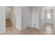 Bright hallway showcases wood-look floors, access to stairs, and a built-in drop zone at 419 Burr St, Indian Trail, NC 28079