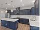 The modern kitchen features a central island, stainless appliances, and stylish pendant lighting at 419 Burr St, Indian Trail, NC 28079