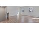 Light-filled living space with durable wood-look flooring, staircase access, and multiple large windows at 419 Burr St, Indian Trail, NC 28079