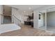 Spacious living room with wood floors leading to an open kitchen and outdoor patio at 419 Burr St, Indian Trail, NC 28079