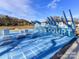 Modern community playground features unique obstacles and workout stations on bright blue surface at 419 Burr St, Indian Trail, NC 28079