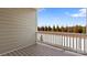 Outdoor porch area with brown decking overlooking treelined street in a new community at 419 Burr St, Indian Trail, NC 28079