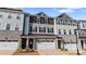 A closer view of inviting townhomes featuring a stone and siding facade, with a well-maintained landscape at 419 Burr St, Indian Trail, NC 28079