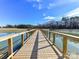 Picturesque wooden walkway spans a serene pond, enhancing the community's natural beauty at 419 Burr St, Indian Trail, NC 28079