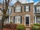 Charming two-story brick townhome with black shutters and door and manicured landscaping at 4909 Prosperity Ridge Rd, Charlotte, NC 28269