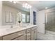 Bright bathroom featuring double sinks, neutral colors, and walk-in shower at 6419 Mallow Crossing Ln, Charlotte, NC 28213