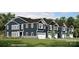 Beautiful new construction home featuring a two-car garage, stone accents, and well-manicured lawn at 6419 Mallow Crossing Ln, Charlotte, NC 28213