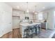 Modern kitchen with white cabinets, stainless steel appliances, and a spacious island with seating at 6419 Mallow Crossing Ln, Charlotte, NC 28213