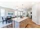 Modern kitchen with a large island, white cabinetry, and pendant lighting, open to the dining area and living space at 6419 Mallow Crossing Ln, Charlotte, NC 28213