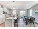 Bright kitchen connected to dining area, featuring a central island, modern lighting, and ample counter space at 6419 Mallow Crossing Ln, Charlotte, NC 28213
