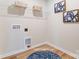 Laundry room offers a pet nook, storage shelves, and decoratively framed wall art at 6419 Mallow Crossing Ln, Charlotte, NC 28213