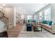 Open-concept living area with modern furnishings, hardwood floors, and seamless flow to the kitchen at 6419 Mallow Crossing Ln, Charlotte, NC 28213