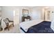 Bright main bedroom features neutral colors and a doorway to the ensuite bathroom at 6419 Mallow Crossing Ln, Charlotte, NC 28213