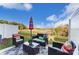 Inviting patio with a seating area and umbrella offers views of the surrounding landscape at 6419 Mallow Crossing Ln, Charlotte, NC 28213