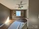 Bedroom featuring wood flooring, a ceiling fan, and a window, creating a serene space to rest and unwind at 7201 Gilead Rd, Huntersville, NC 28078