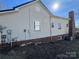 Side exterior elevation of the home showing the siding and chimney at 7201 Gilead Rd, Huntersville, NC 28078