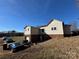 Exterior view of the home with a two-car garage and blue car, on a grassy lot at 7201 Gilead Rd, Huntersville, NC 28078