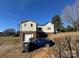 Exterior view of the home with a two-car garage and blue car at 7201 Gilead Rd, Huntersville, NC 28078