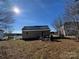 Exterior view of the home with a metal roof, backyard, and lush greenery at 7201 Gilead Rd, Huntersville, NC 28078