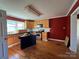 Traditional kitchen with wood cabinets, black appliances, an island for extra counter space, and a window at 7201 Gilead Rd, Huntersville, NC 28078