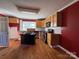 Traditional kitchen with wood cabinets, black appliances, and an island for extra counter space at 7201 Gilead Rd, Huntersville, NC 28078