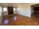 Living room featuring hardwood floors, a brick fireplace, and bright windows, ready for cozy gatherings and relaxation at 7201 Gilead Rd, Huntersville, NC 28078