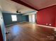 Bright living room featuring hardwood floors, a ceiling fan, and a sliding glass door to the outside at 7201 Gilead Rd, Huntersville, NC 28078