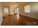 Sunlit living room with beautiful hardwood floors, offering a bright and inviting space for Gathering and guests at 7201 Gilead Rd, Huntersville, NC 28078