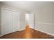 Neutral bedroom featuring wood floors, closet and trim details throughout at 8730 Rittenhouse Cir, Charlotte, NC 28270
