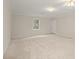 Spacious bedroom featuring neutral carpet and a door to the outside at 8730 Rittenhouse Cir, Charlotte, NC 28270