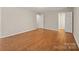 Neutral bedroom featuring wood-look floors and multiple doors leading to other rooms at 8730 Rittenhouse Cir, Charlotte, NC 28270