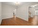 Open dining room featuring wood floors, a decorative chandelier, and easy access to other living spaces at 8730 Rittenhouse Cir, Charlotte, NC 28270