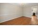 Bright dining room features wood floors, chair rail, and views into the kitchen at 8730 Rittenhouse Cir, Charlotte, NC 28270
