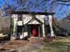 Traditional home with red front door, white siding and black trim at 8730 Rittenhouse Cir, Charlotte, NC 28270