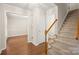 Inviting entryway with wood floors, staircase and entry to a large living space at 8730 Rittenhouse Cir, Charlotte, NC 28270