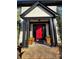 Eye-catching red front door with planter boxes at entry at 8730 Rittenhouse Cir, Charlotte, NC 28270
