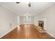 Spacious living room boasts a fireplace, wood floors, and a door to the exterior at 8730 Rittenhouse Cir, Charlotte, NC 28270