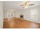 Spacious living room with wood floors, fireplace, and double doors to the exterior at 8730 Rittenhouse Cir, Charlotte, NC 28270