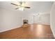 Bright living room offers a fireplace with white trim, and wood floors at 8730 Rittenhouse Cir, Charlotte, NC 28270