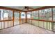 Cozy screened porch with wood flooring and ceiling fan, perfect for outdoor relaxation at 8730 Rittenhouse Cir, Charlotte, NC 28270